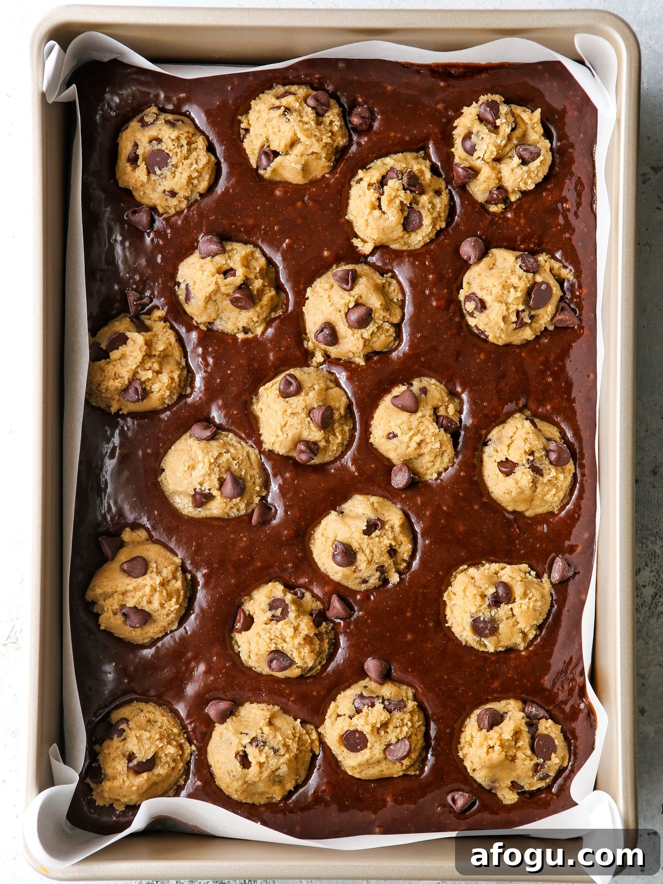 cookie dough balls in brownie batter in pan