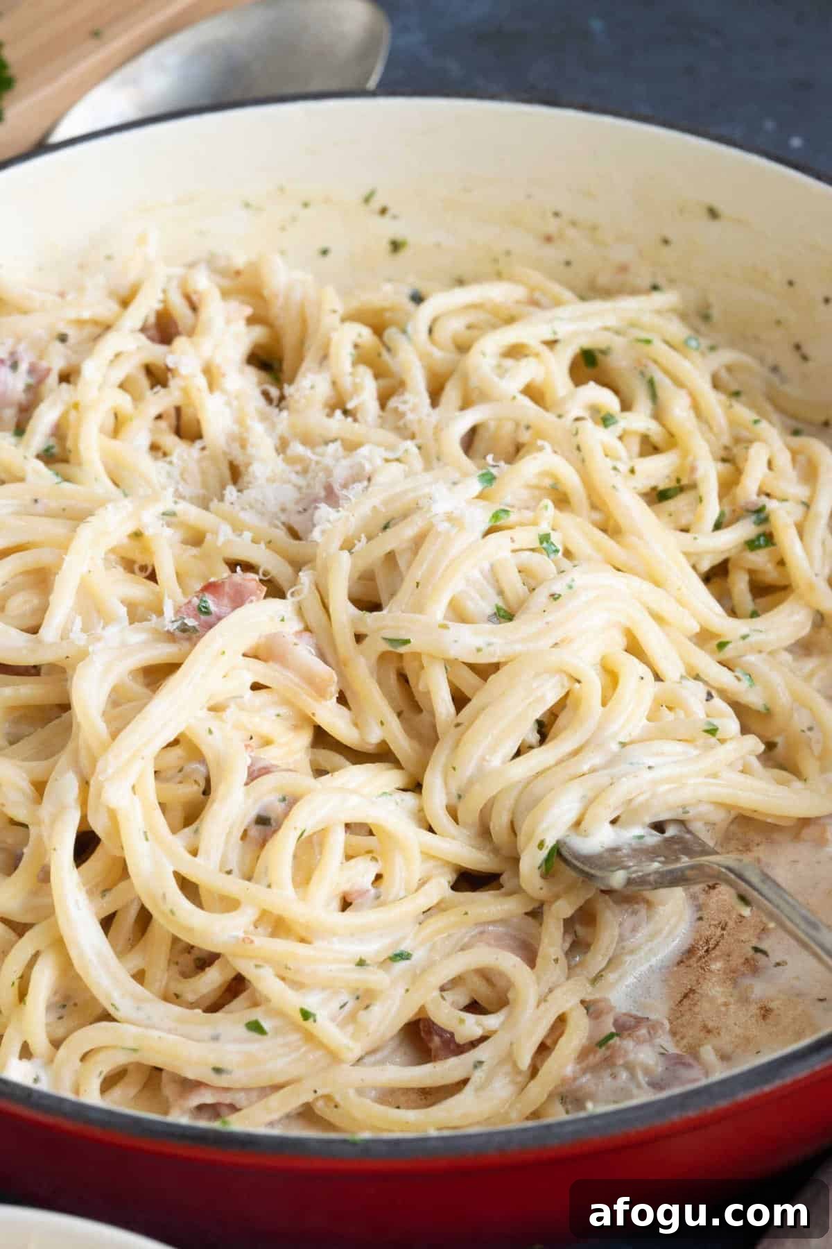 A pan of creamy Boursin pasta with bacon.