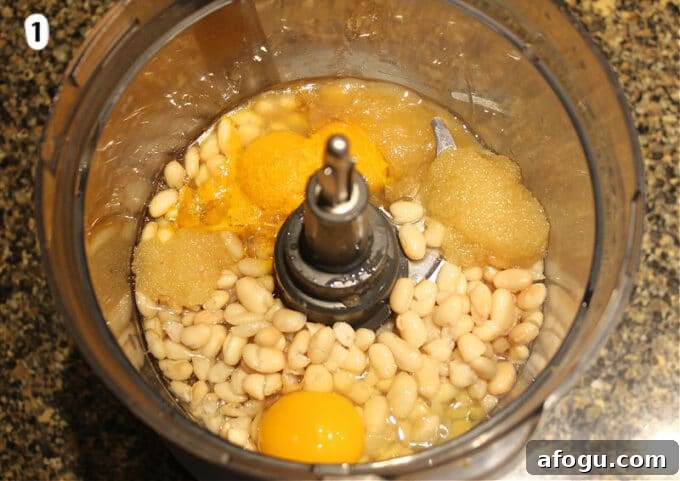 Vanilla cupcake ingredients in a food processor.