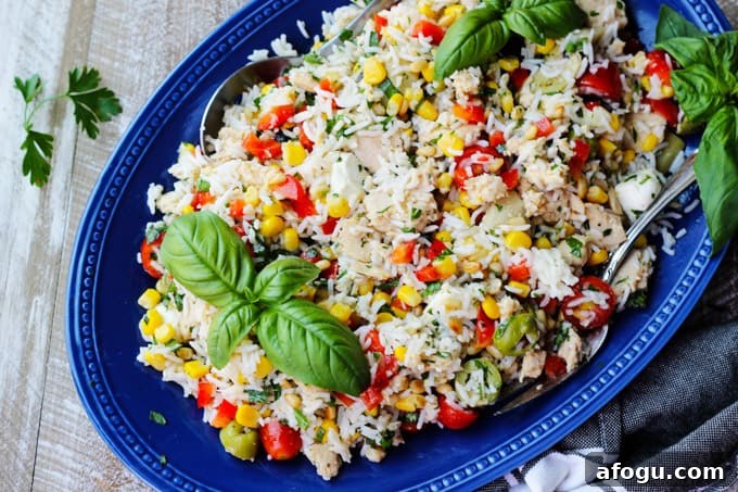 Italian Rice Salad with Tuna Italian rice salad with tuna on a blue plate with towel on a side