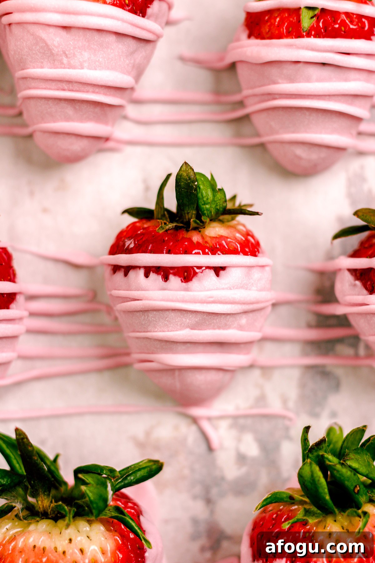 Drizzling chocolate over strawberries