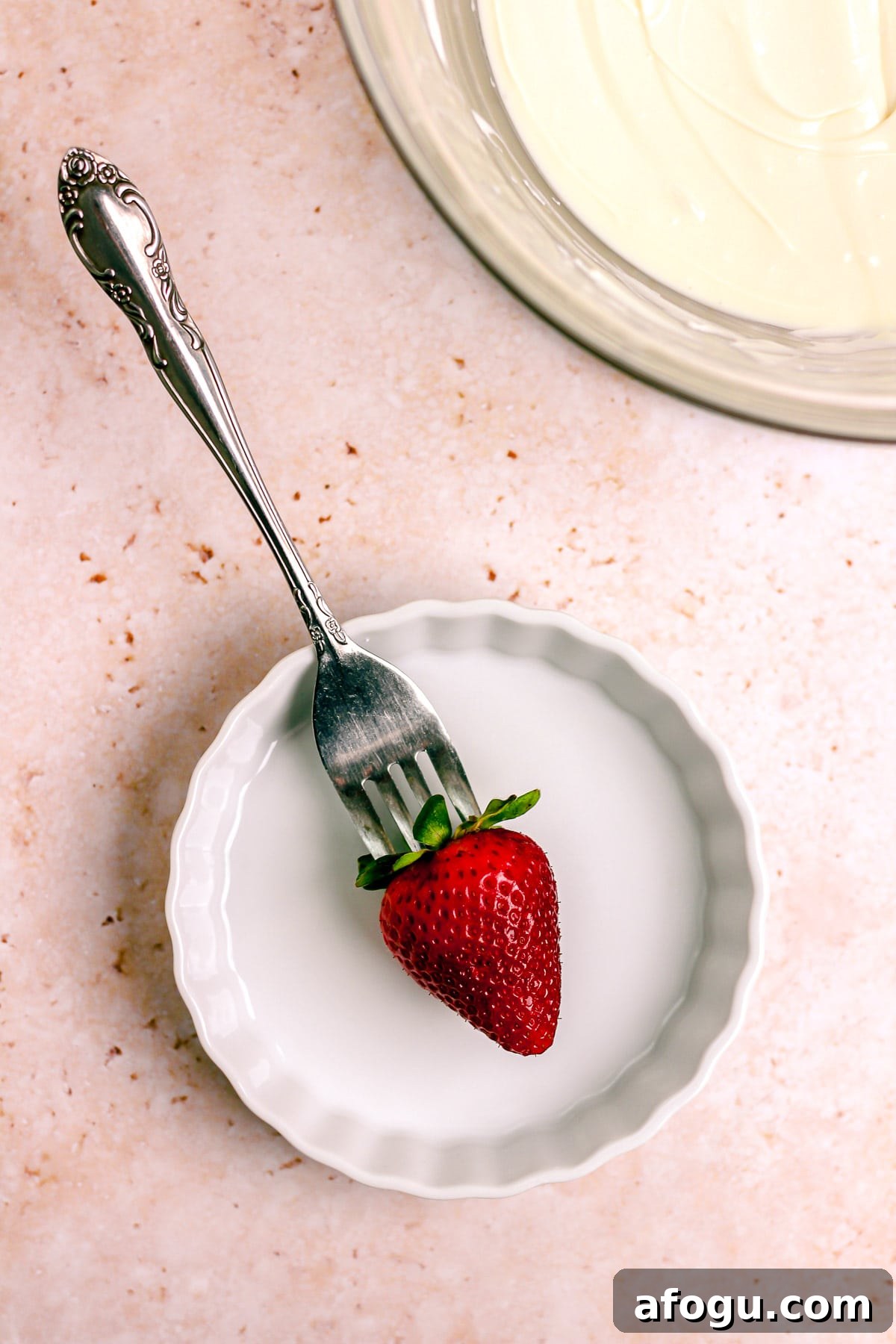 Poking strawberry with fork