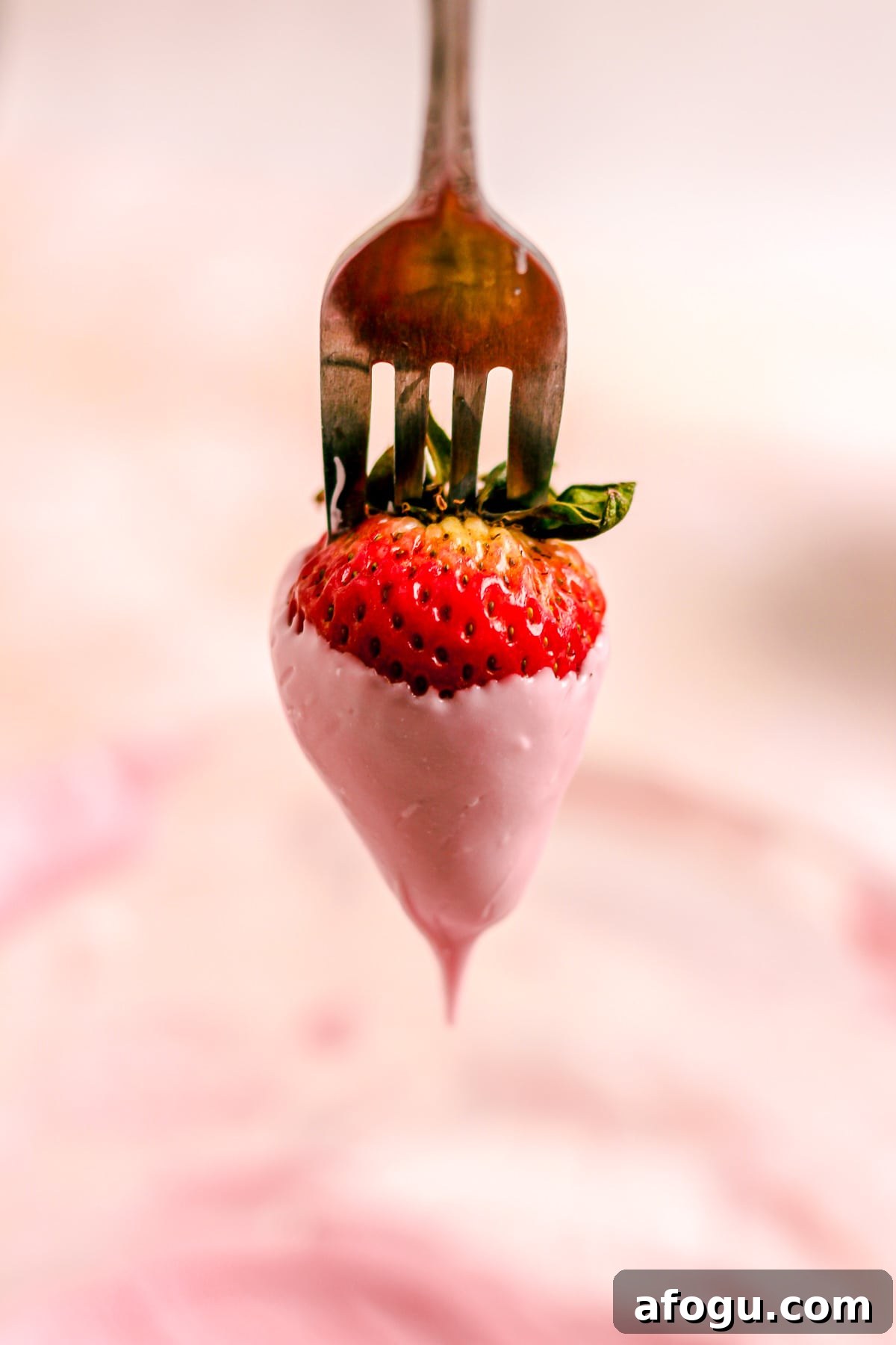 Dipping strawberry in chocolate