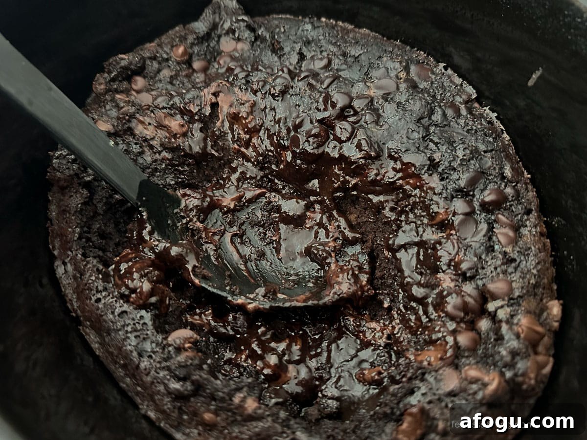 Gluten-Free Slow Cooker Chocolate Lava Cake Recipe 7 A black serving spoon in the lava cake.