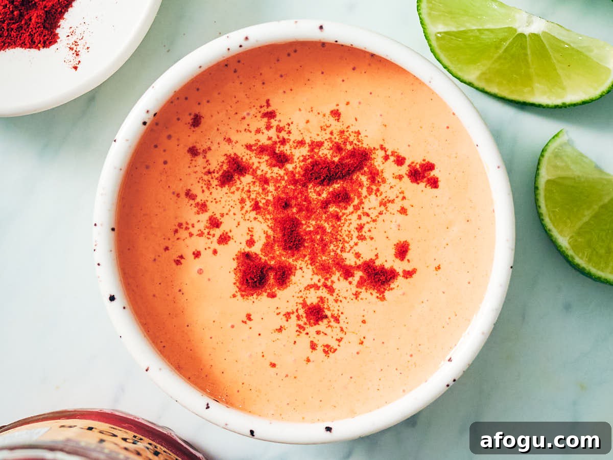 Smoky Red Pepper Crema in a bowl topped with smoked paprika.