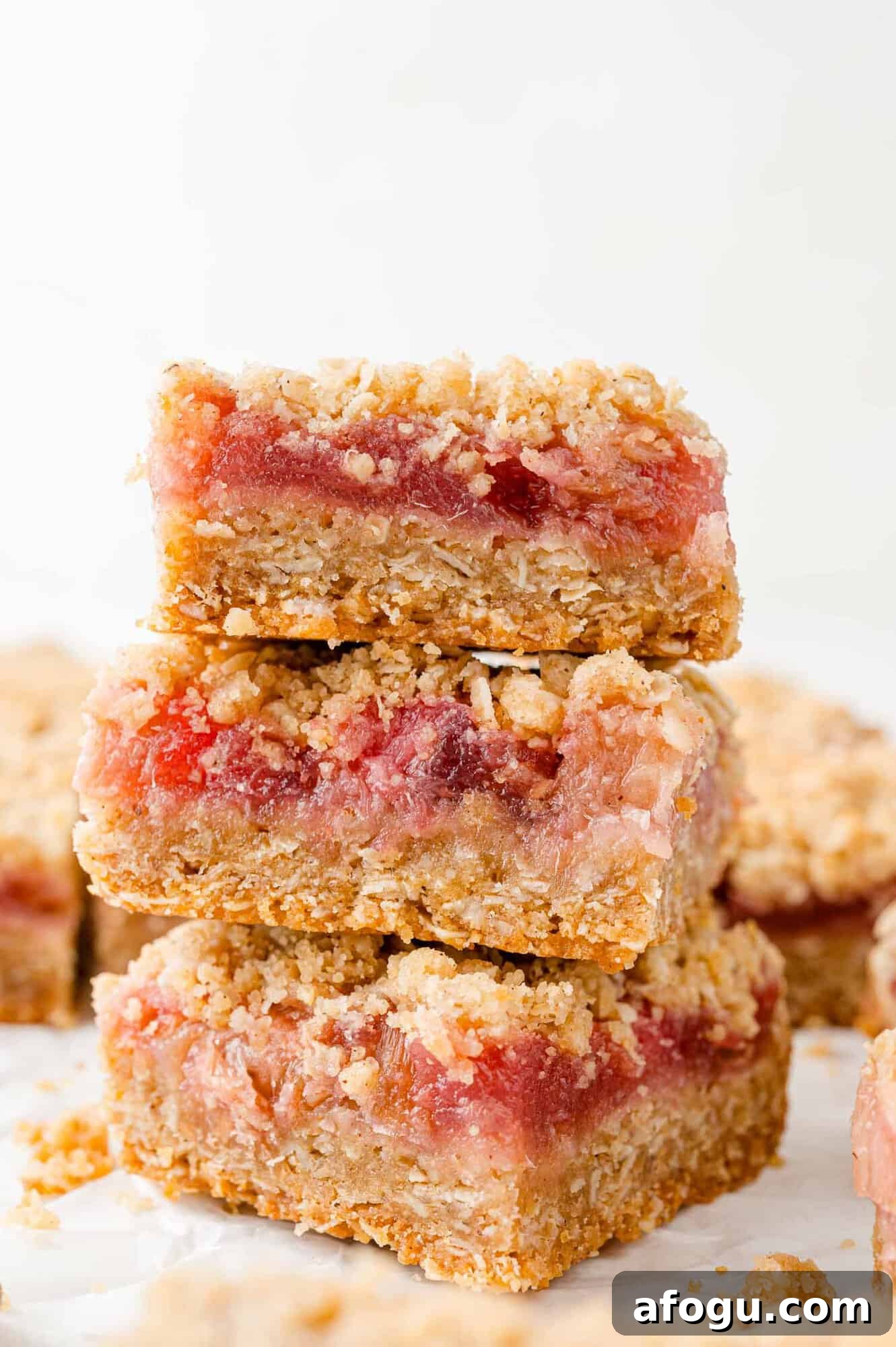 Stack of three rhubarb crumb bars.