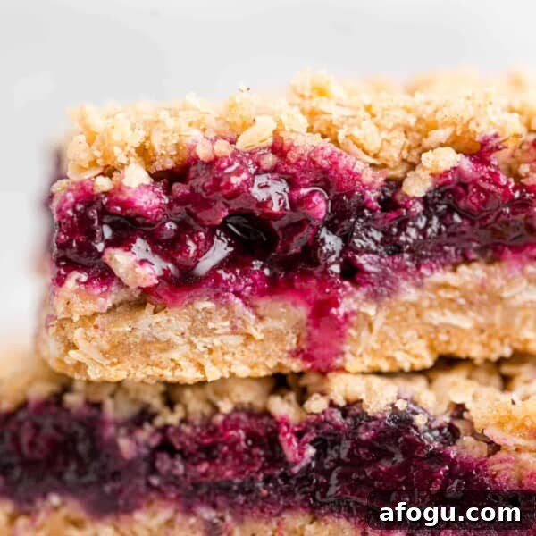 Blueberry crumble bars stacked on top of each other.