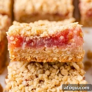 Rhubarb bars, with crumb topping, stacked on each other.
