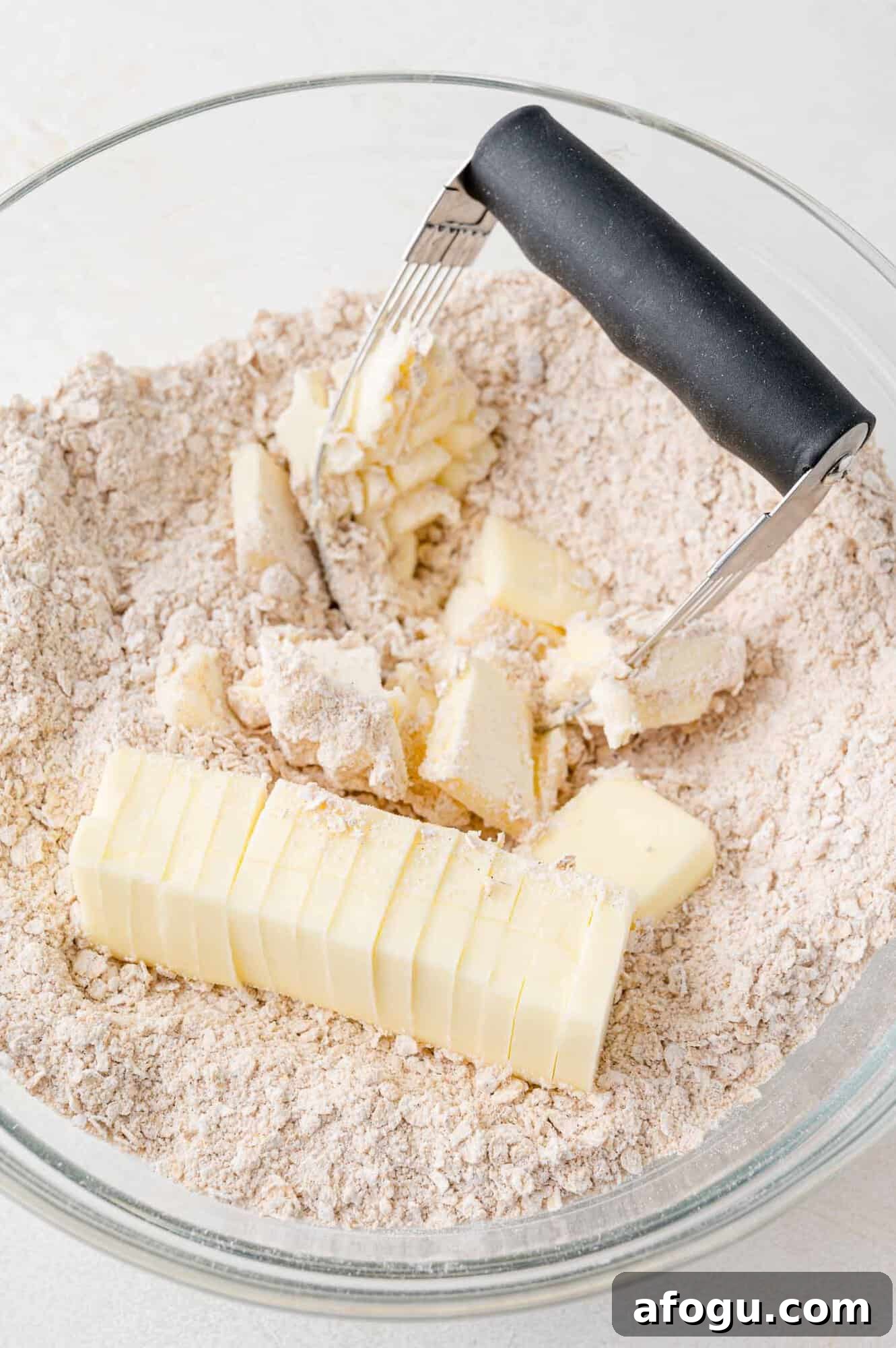 Butter being cut in to dry ingredients.