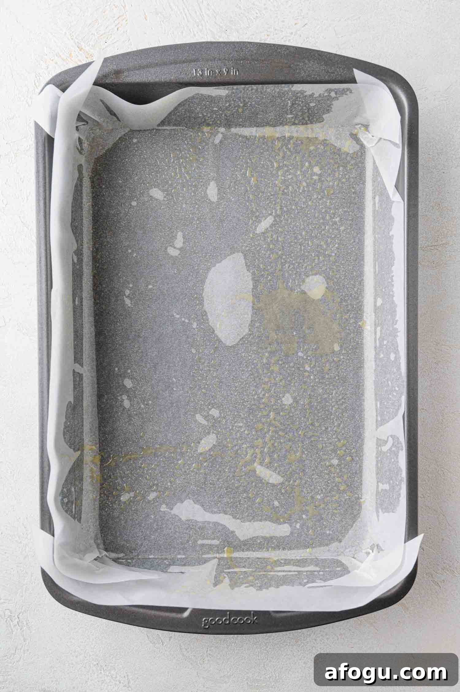 Baking dish prepared with parchment paper and nonstick baking spray.