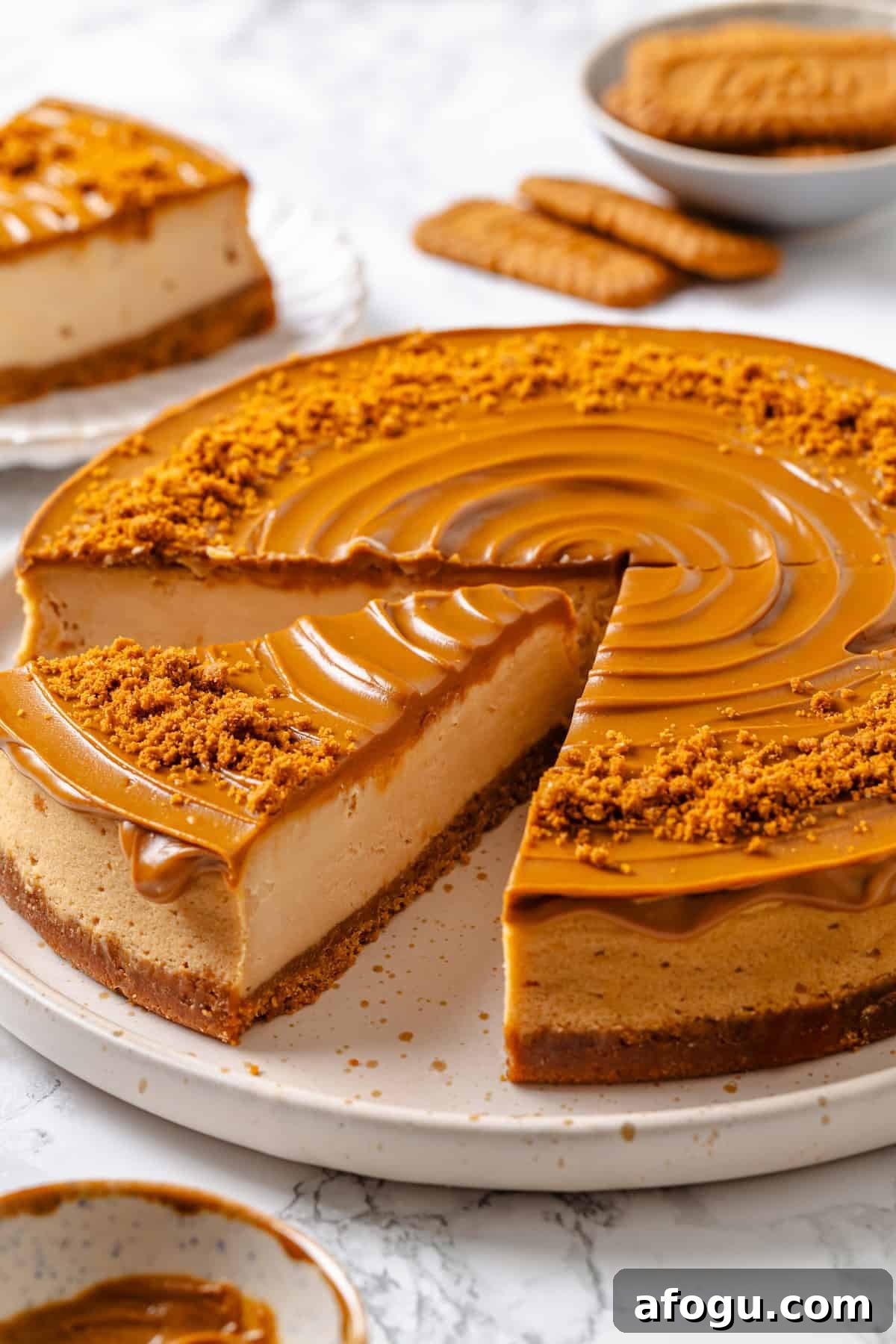 Slice of Biscoff cheesecake cut from rest of cake.