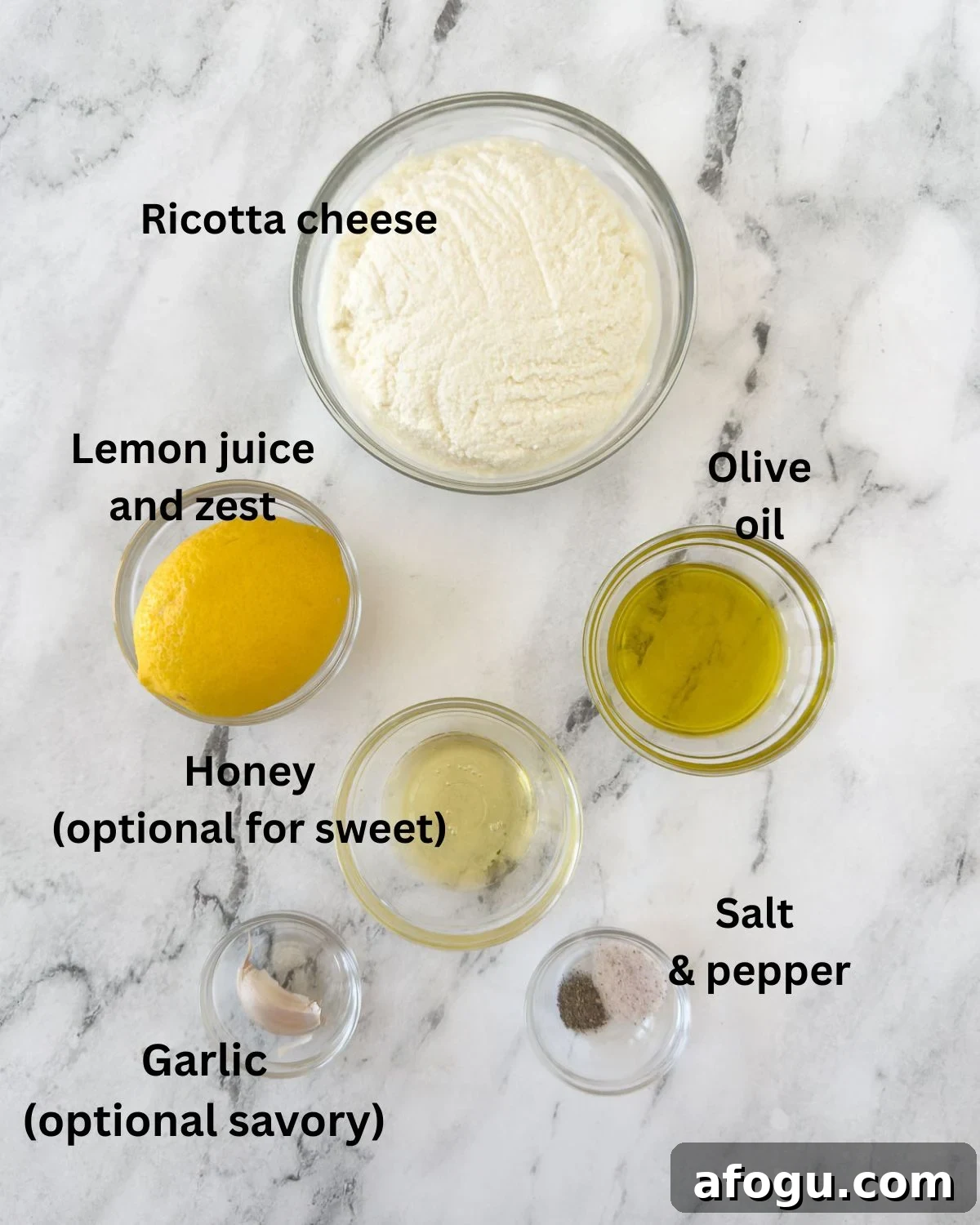 Ingredients for whipped ricotta dip in prep bowls on a counter.
