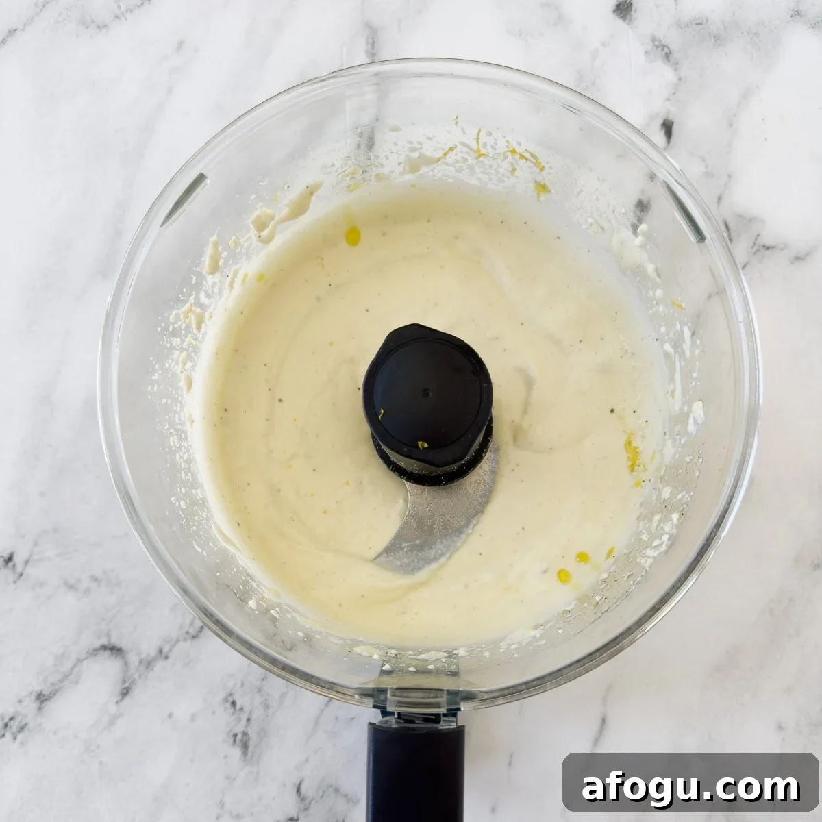 Pureed whipped ricotta cheese dip in a food processor.