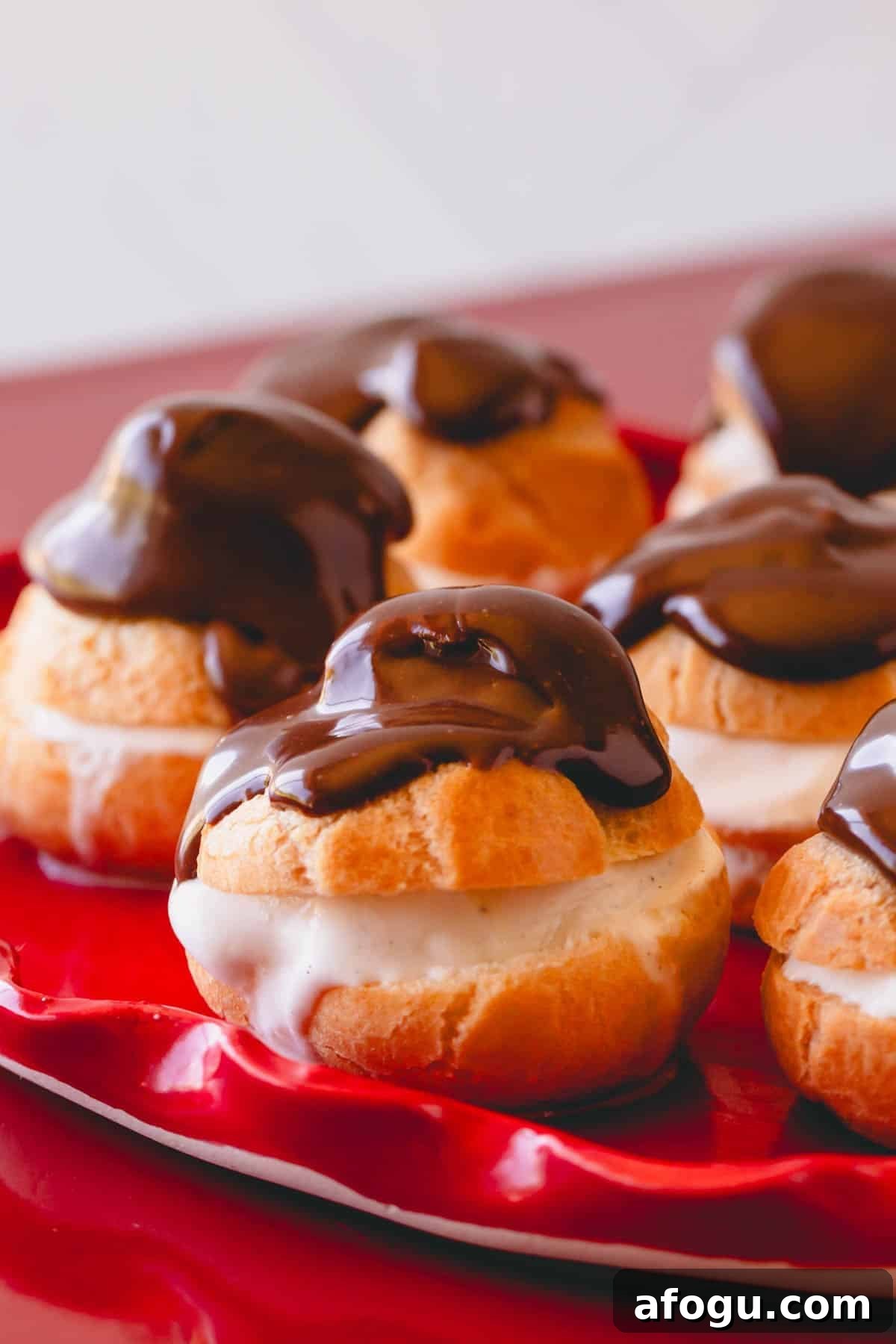 Chocolate profiteroles on a plate.