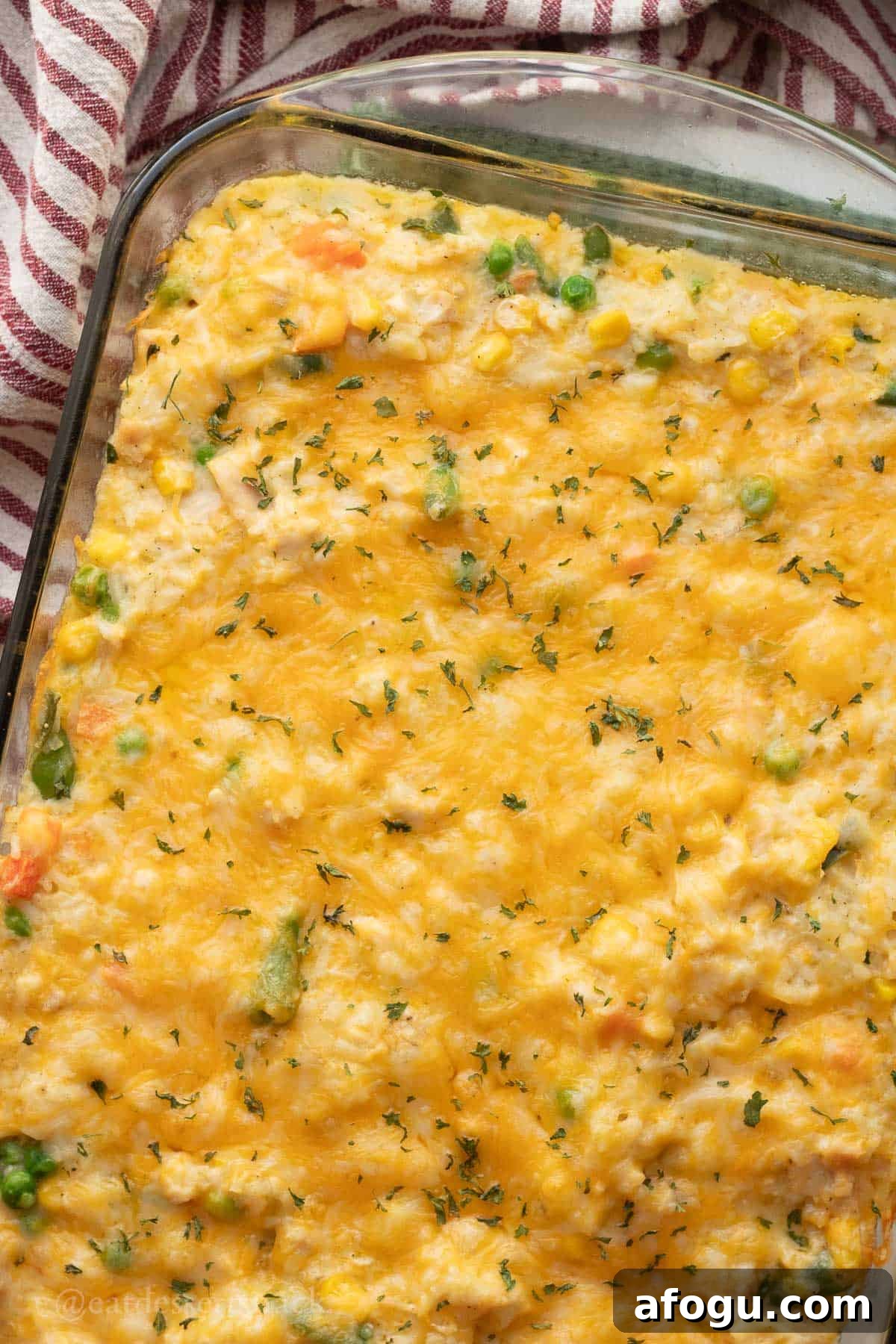Baked chicken rice veggie casserole in glass baking dish.