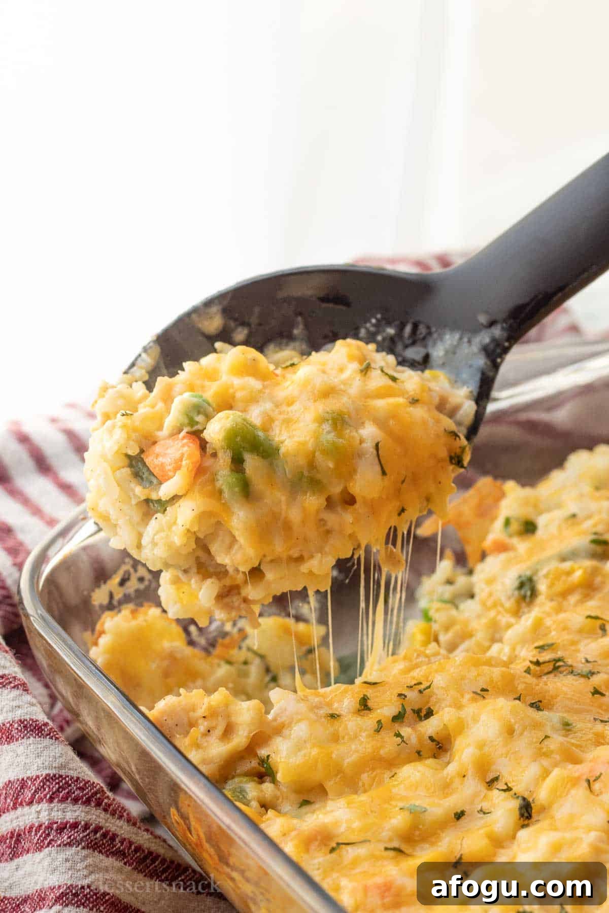 Spoonful of melty cheese rice casserole.