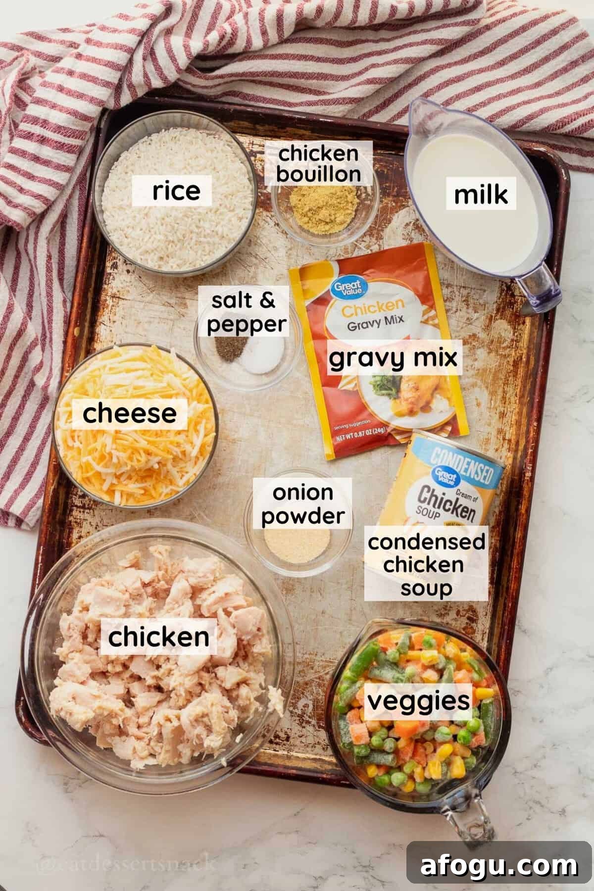 Labeled ingredients for chicken rice and veggies casserole in glass dishes on metal pan.