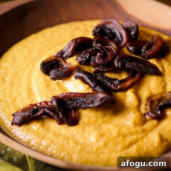 A bowl of Curried Roasted Cauliflower Soup with Crispy Fried Mushrooms sprinkled over the top.