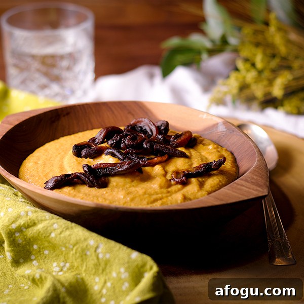 A bowl of Curried Roasted Cauliflower Soup with Crispy Fried Mushrooms sprinkled over the top.