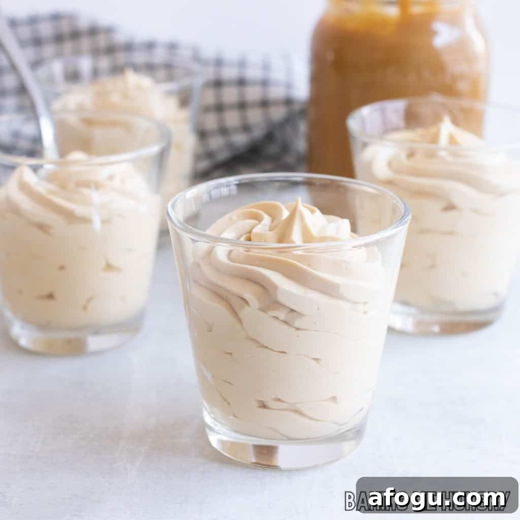 caramel mousse in small glasses with a jar of dulce de leche caramel sauce behind