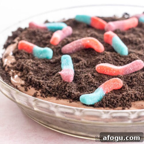 mud pie recipe with gummy worms shown close up in glass pie plate