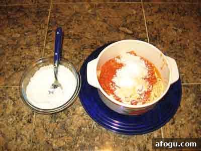 Makaronada topped with myzithra cheese.