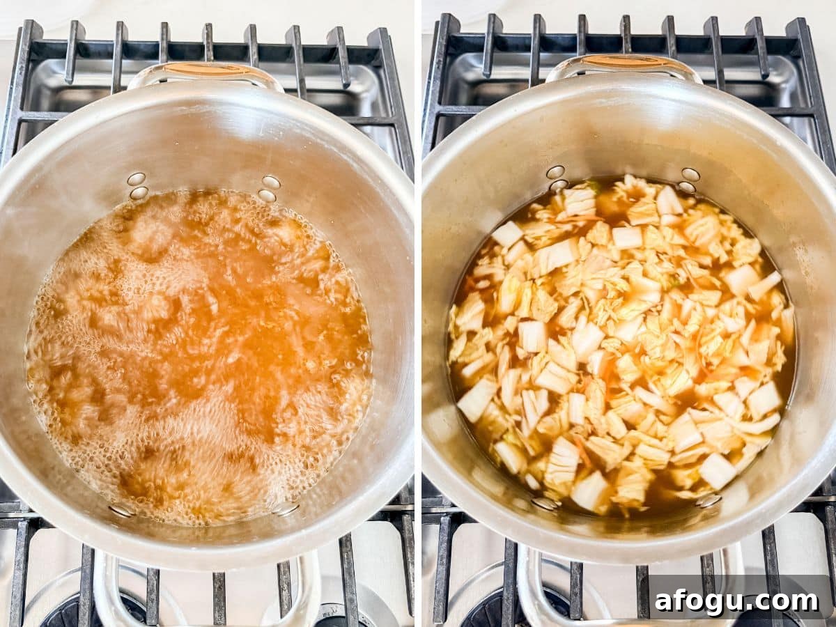 Asian Cabbage and Pork Meatball Soup Recipe 6 Broth boiling in a pot and then cabbage and carrots added to the pot.