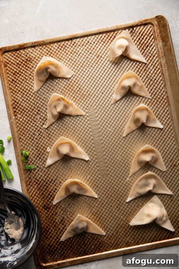 Crispy Baked Cream Cheese Wontons Recipe 7 cream cheese wontons prior to baking on a baking sheet