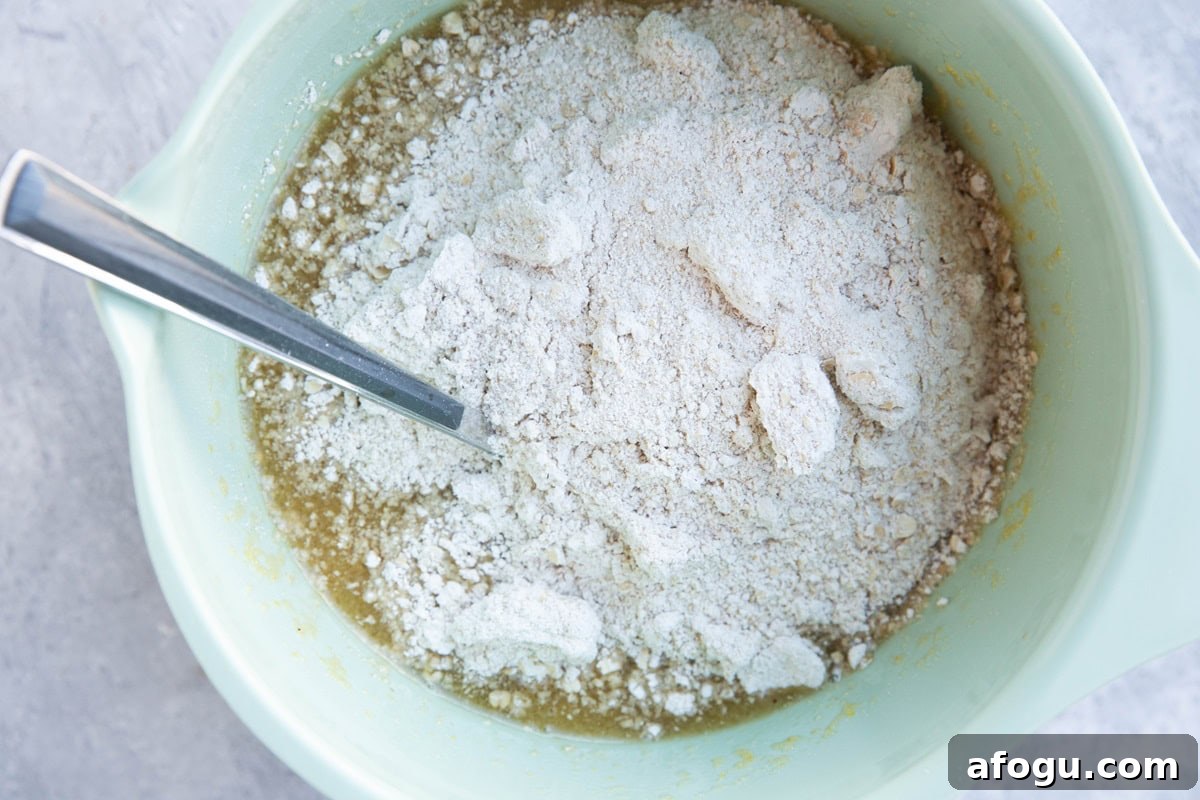 Flour on top of wet ingredients in a mixing bowl.