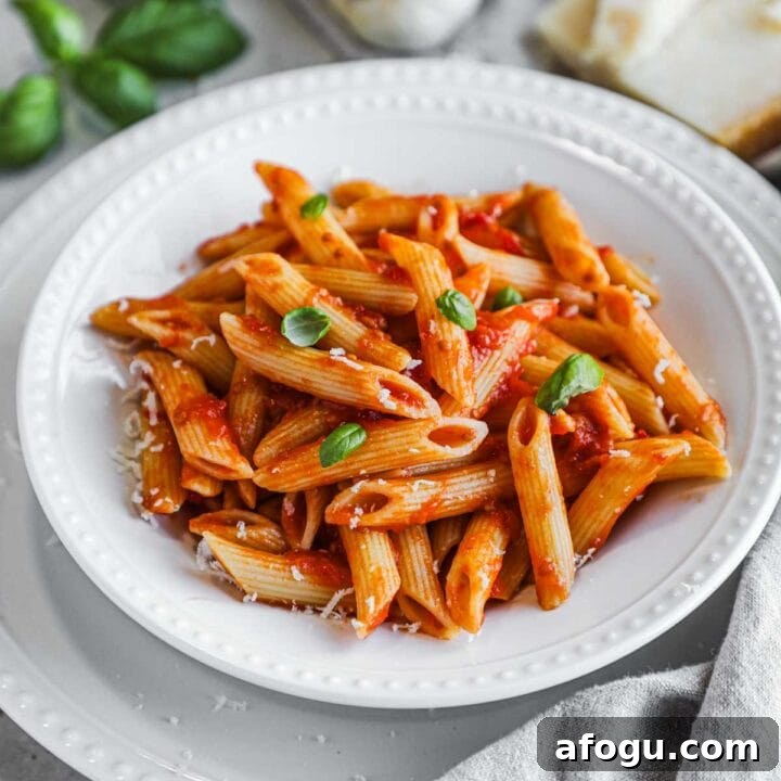 Authentic penne pomodoro made with San Marzano tomatoes and topped with parmigiano-reggiano.