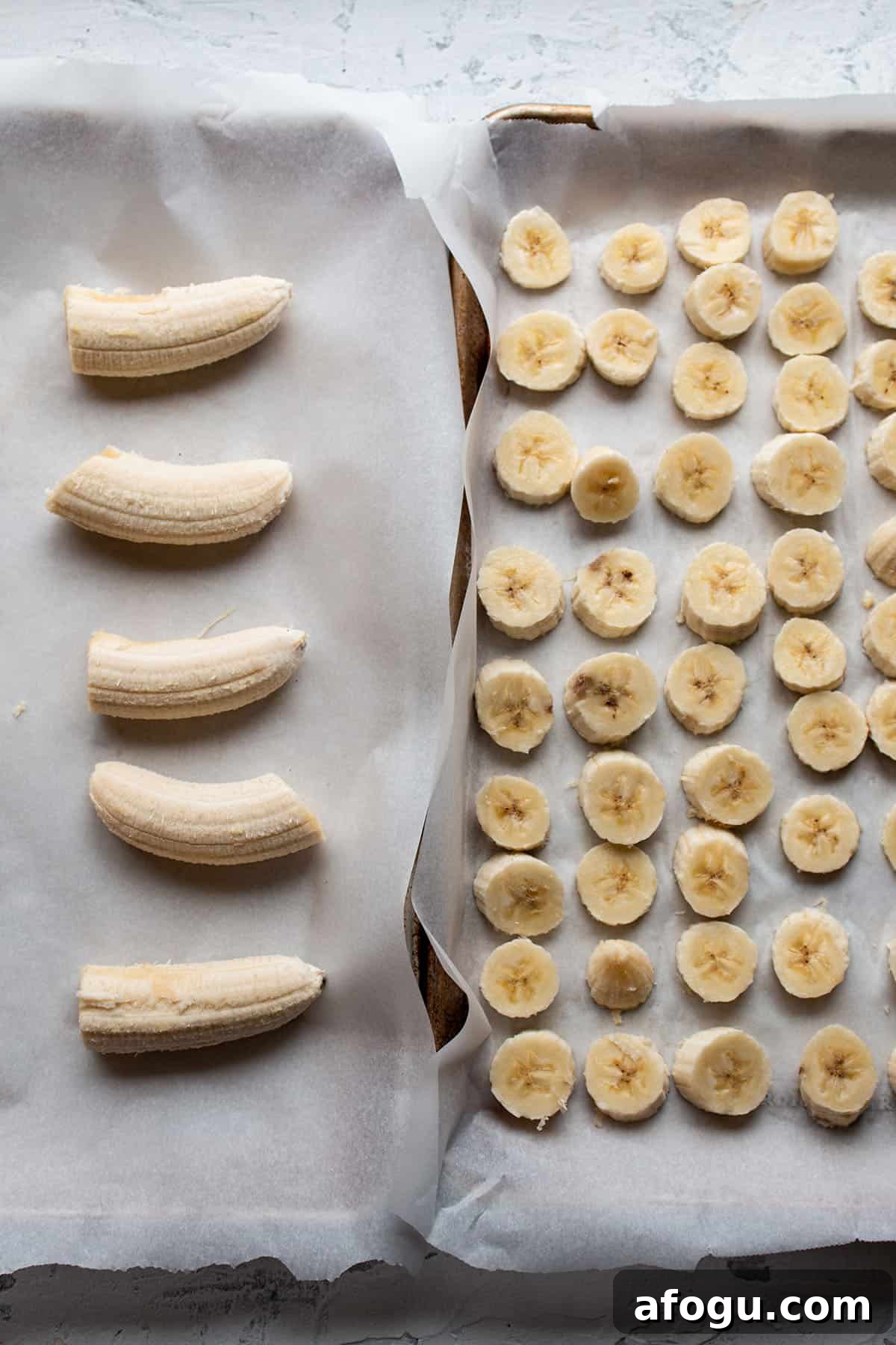 Two sheet pans with parchment and cut up bananas.