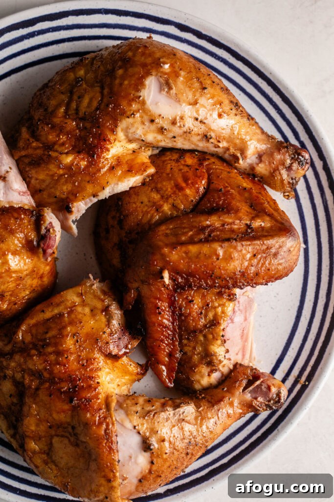 best smoked beer can chicken cut into pieces on plate