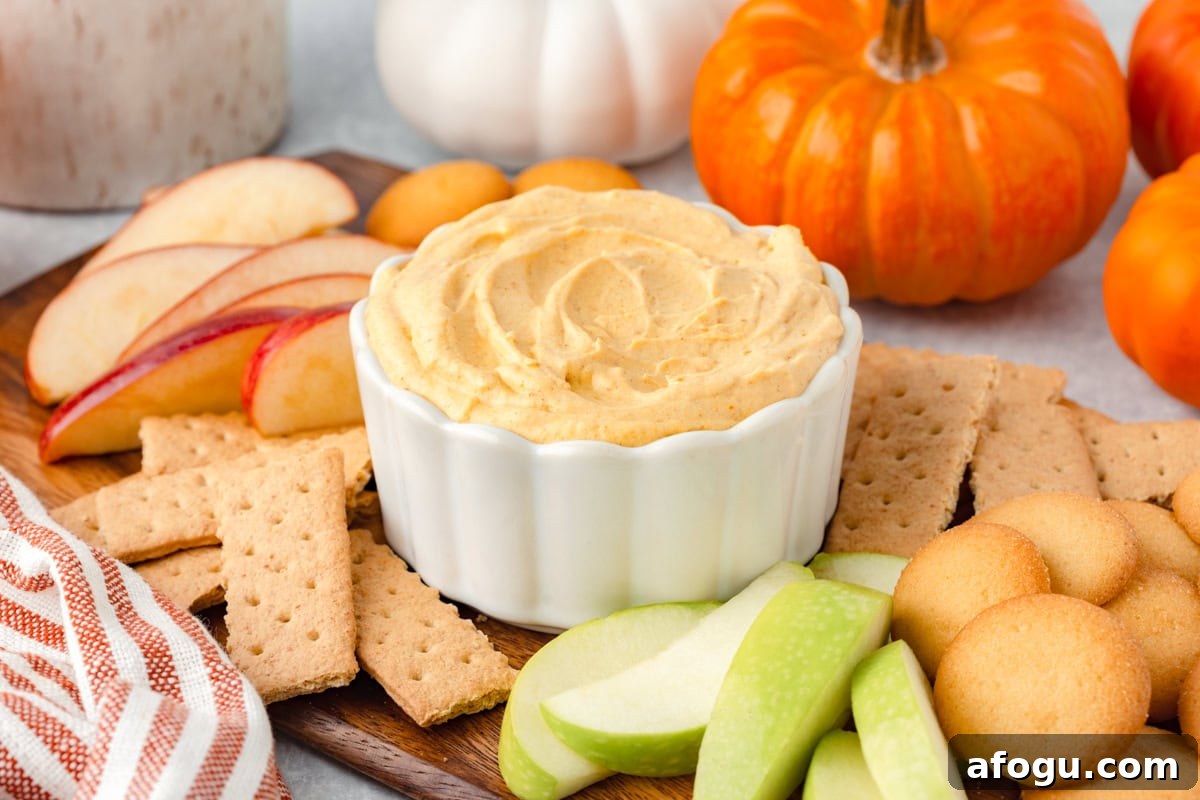 A bowl of creamy pumpkin fluff with dippers.