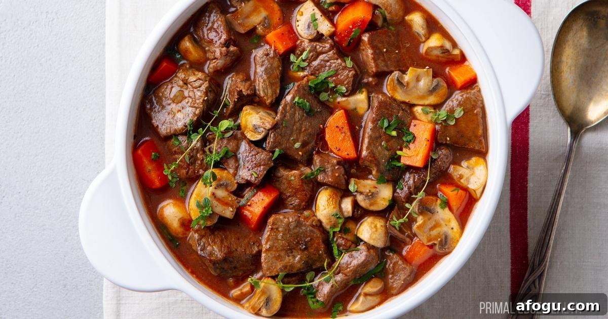 Beef stew in a white pot served with a spoon.