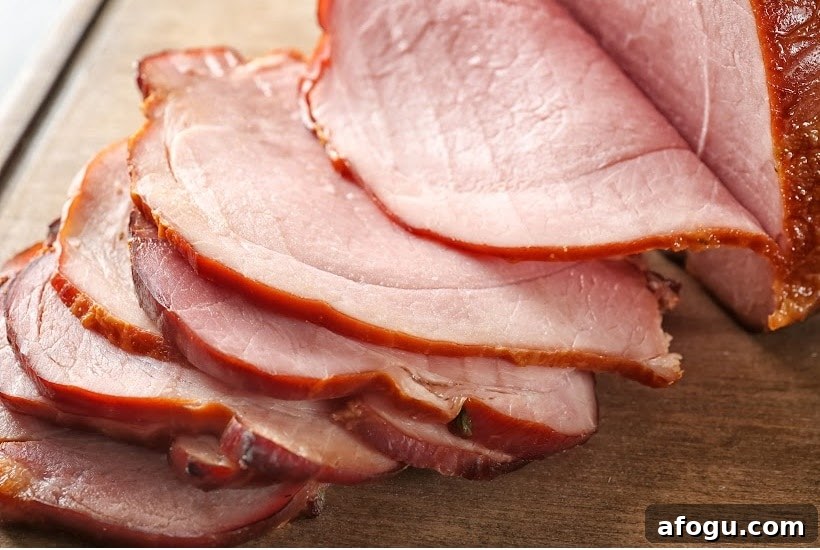 ham slices on a wooden cutting board.
