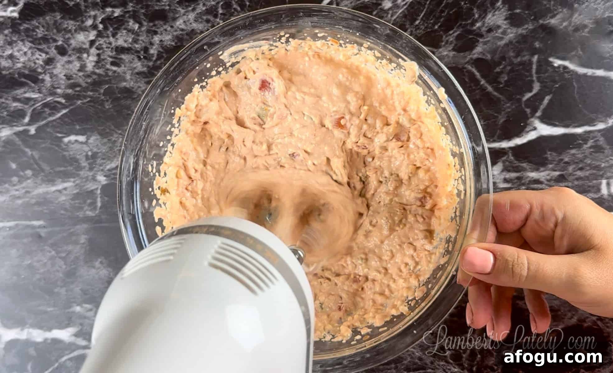 blending cream cheese and salsa in a bowl.