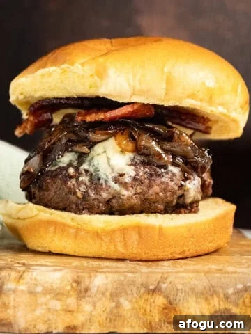 Bacon blue cheese burger on a cutting board.