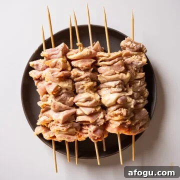 Marinated chicken thighs on skewers.