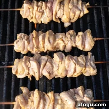 Grilling chicken thigh skewers.