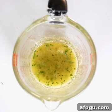 Lemon garlic butter sauce in a measuring cup.