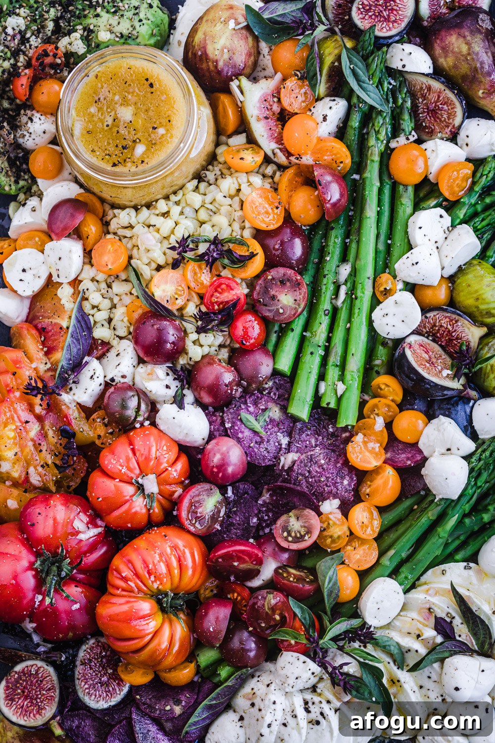Summer Salad Recipe That Keeps Giving All Season Long 2 Summer salad with corn, asparagus, cheese, figs, avocado, tomatoes, basil and a vinaigrette.