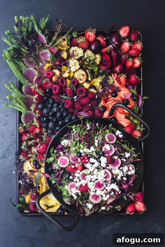 Summer Salad Recipe That Keeps Giving All Season Long 7 summer farmers market bounty made into a salad board! summer fruits, veggies, greens and cheese arranged on a tray on a black background.