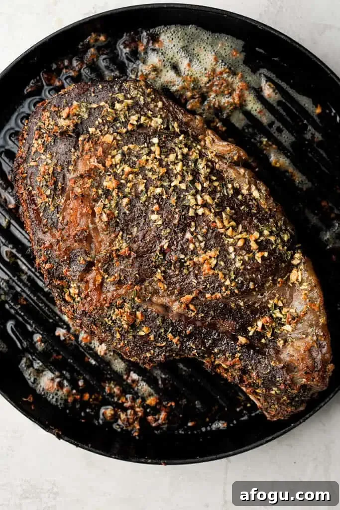 overhead view of a roast prime rib roast resting in a skillet