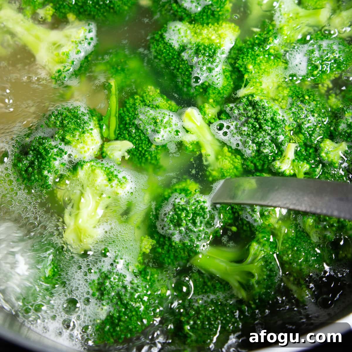 boiling broccoli and pasta in a large pot.