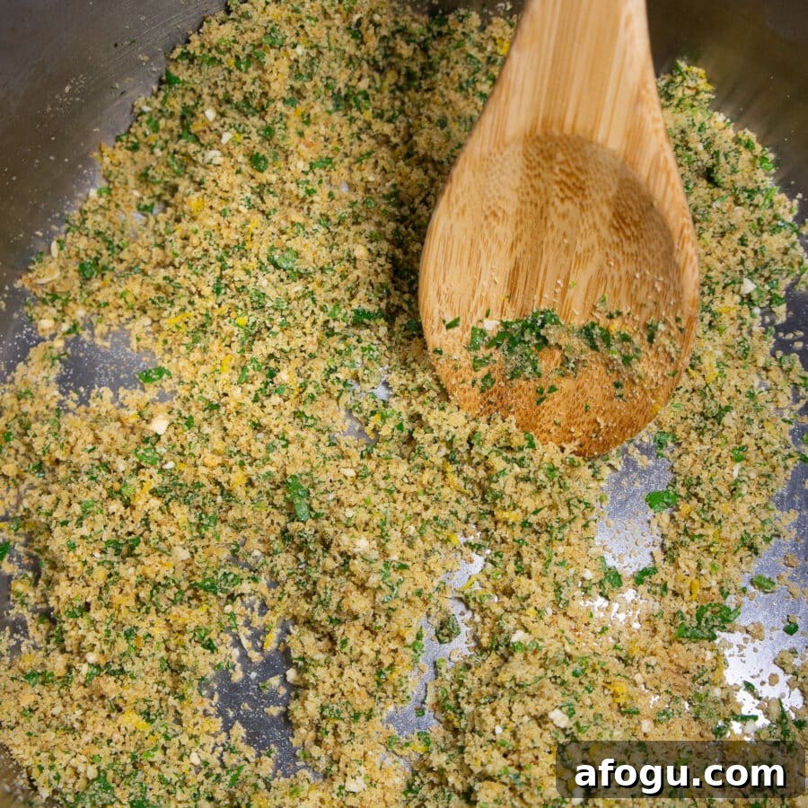 breadcrumbs toasted with herbs and butter in a pot.