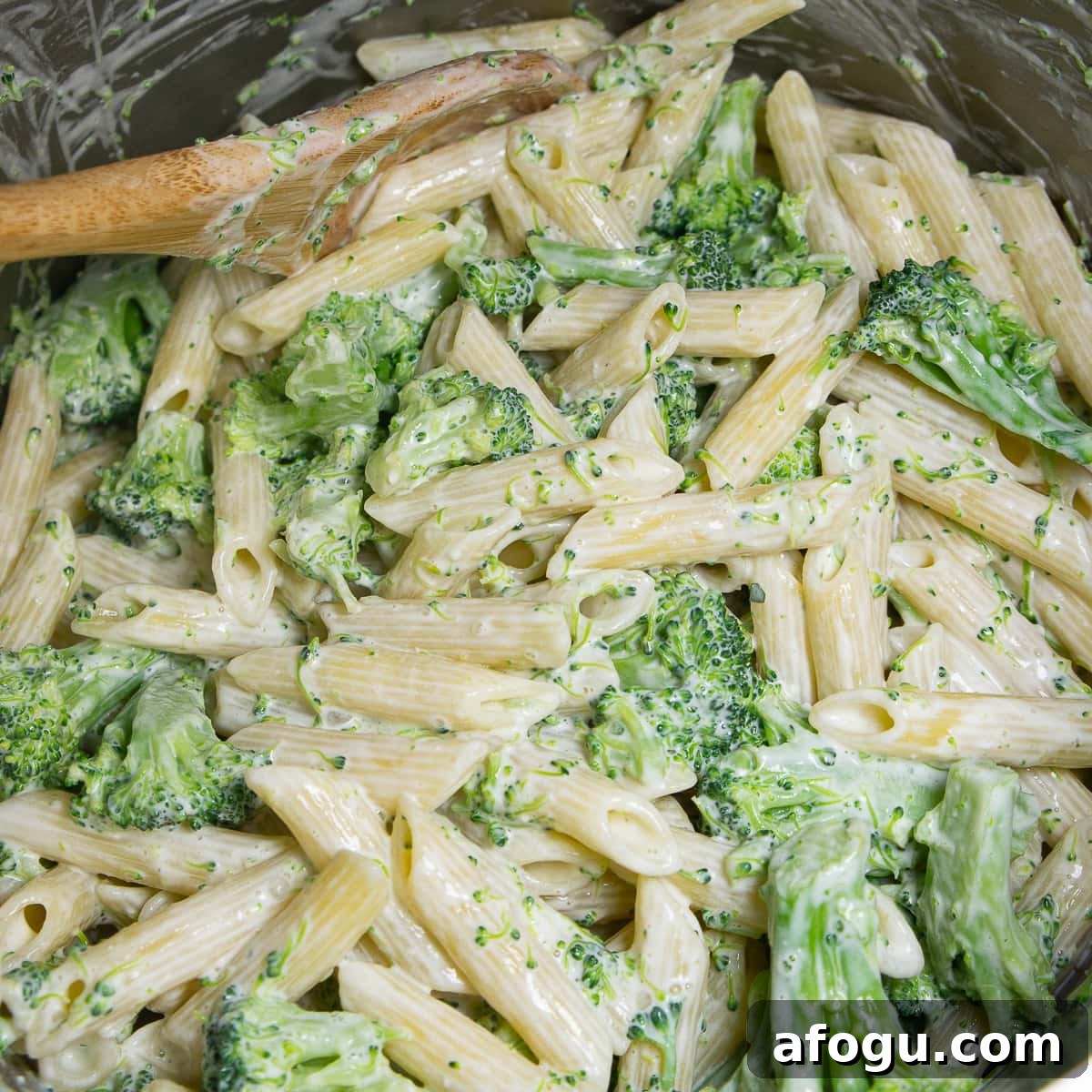 penne and broccoli stirred together in a creamy sauce.