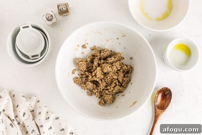 ingredients for keto crackers recipe in a white bowl next to other bowls