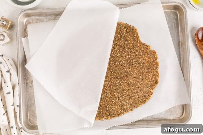 dough between parchment paper for keto cracker recipe