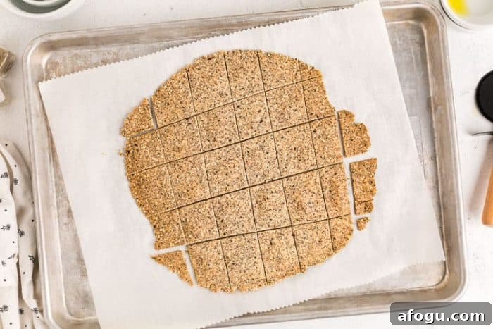 dough cut into pieces on parchment paper for almond flour crackers