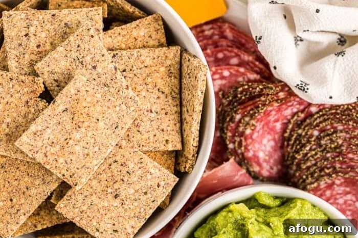 low carb crackers in a bowl next to meats and cheeses